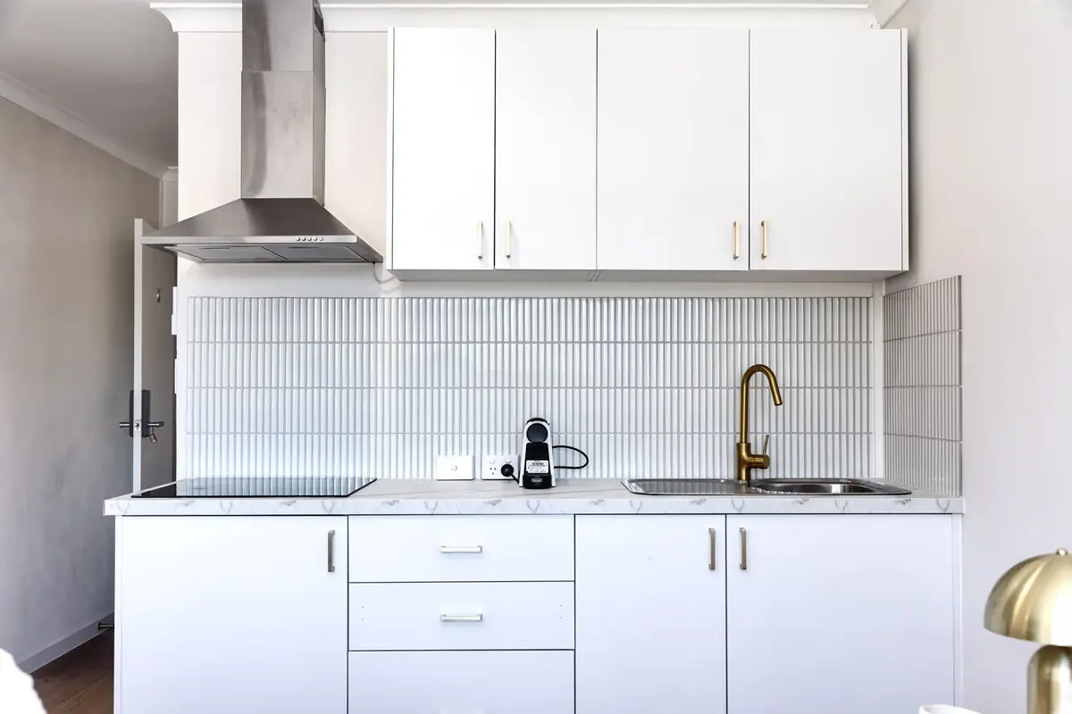 Kitchen with a cooktop, rangehood and dining space