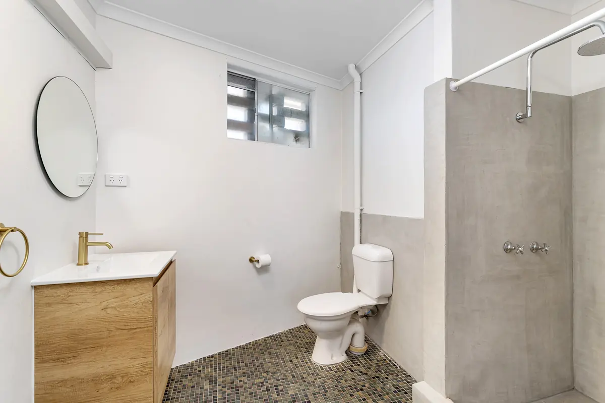 Studio bathroom with a walk-in shower and a timber vanity