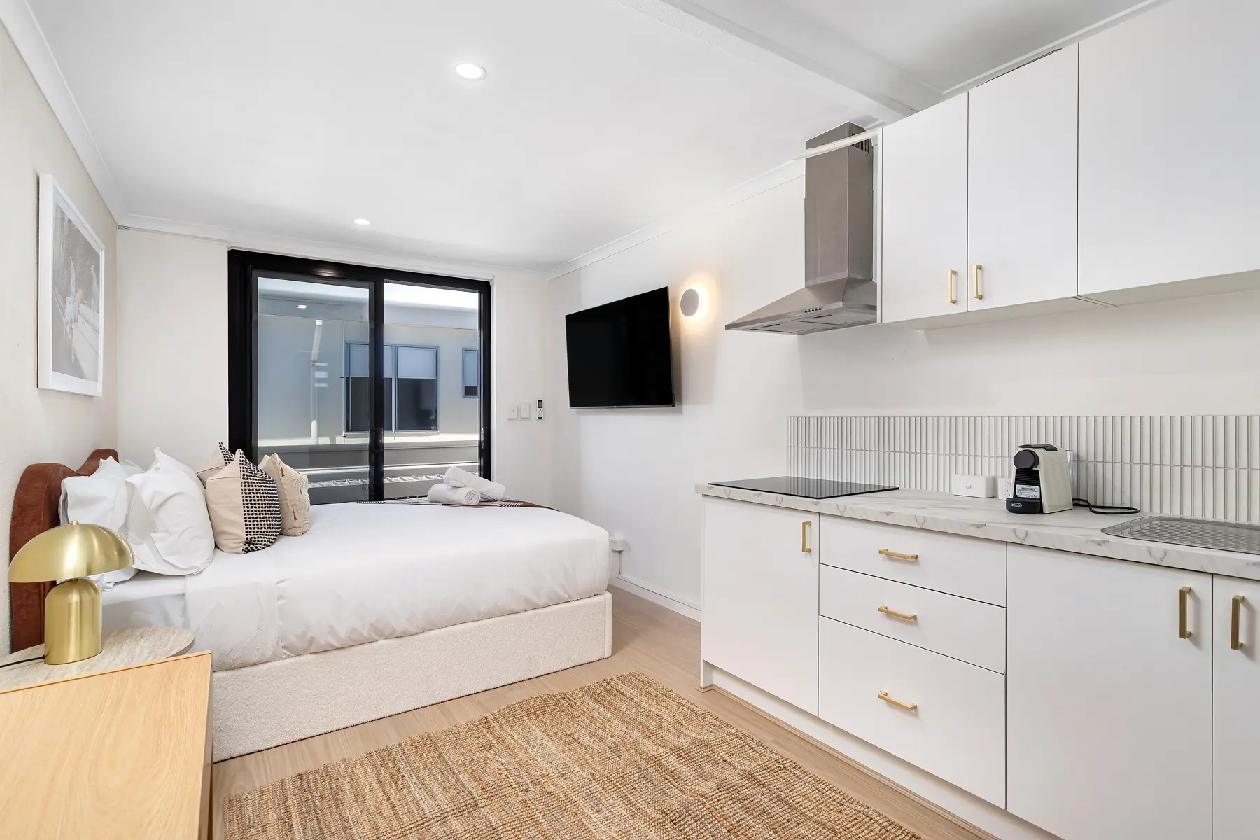 Studio room at Miami Motel with a queen bed and a kitchenette along one wall